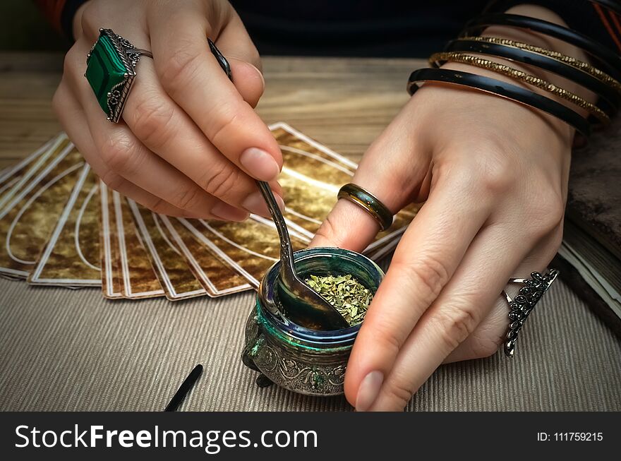 Woman witch prepare a magic potion. Tarot cards. Future reading. Fortune teller concept.