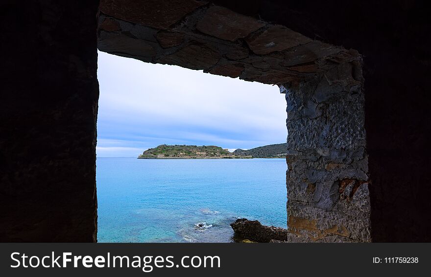 View of the island of Spinalonga with calm sea. Here were lepers, humans with the Hansen`s desease, gulf of Elounda, Crete, Greece.