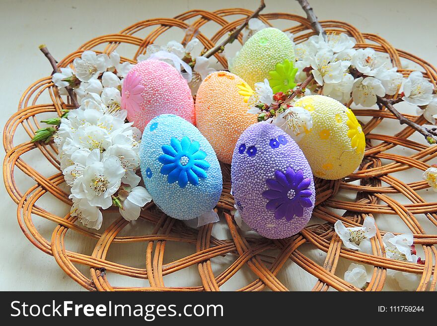 Painted Easter eggs basket and cherry tree blossom. Painted Easter eggs basket and cherry tree blossom