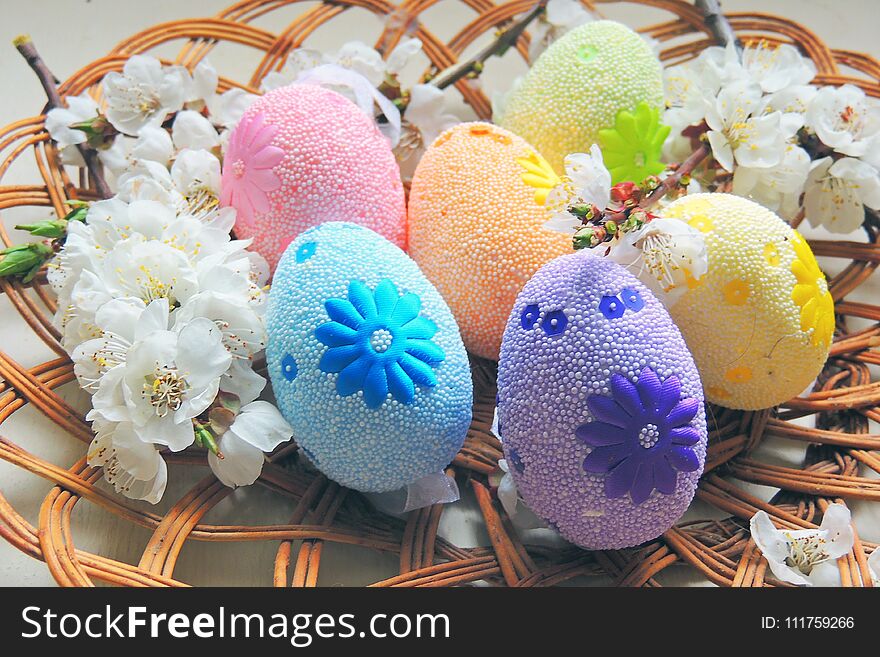 Painted Easter eggs basket and cherry tree blossom. Painted Easter eggs basket and cherry tree blossom