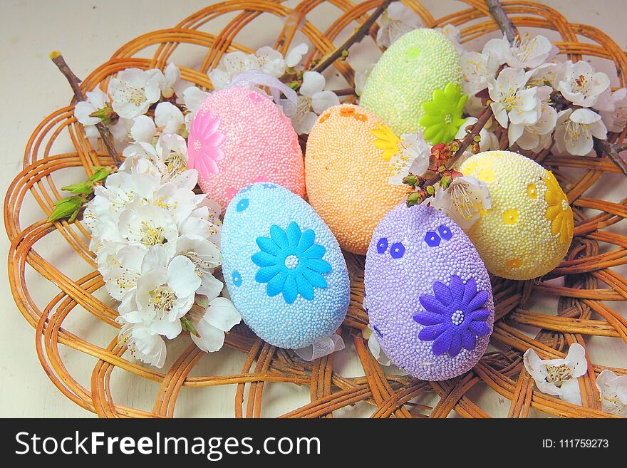 Painted Easter eggs basket and cherry tree blossom. Painted Easter eggs basket and cherry tree blossom