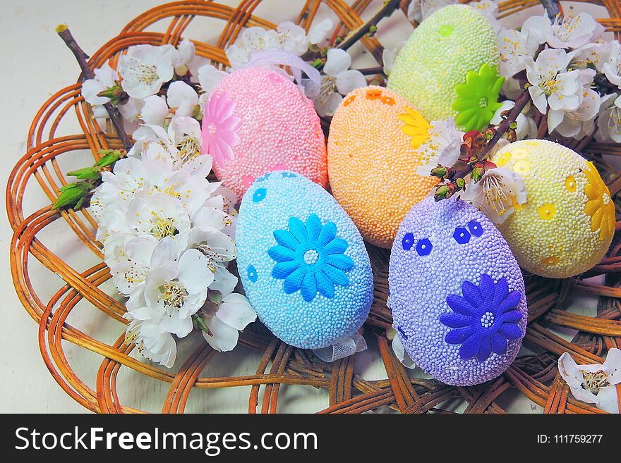 Painted Easter eggs basket and cherry tree blossom. Painted Easter eggs basket and cherry tree blossom