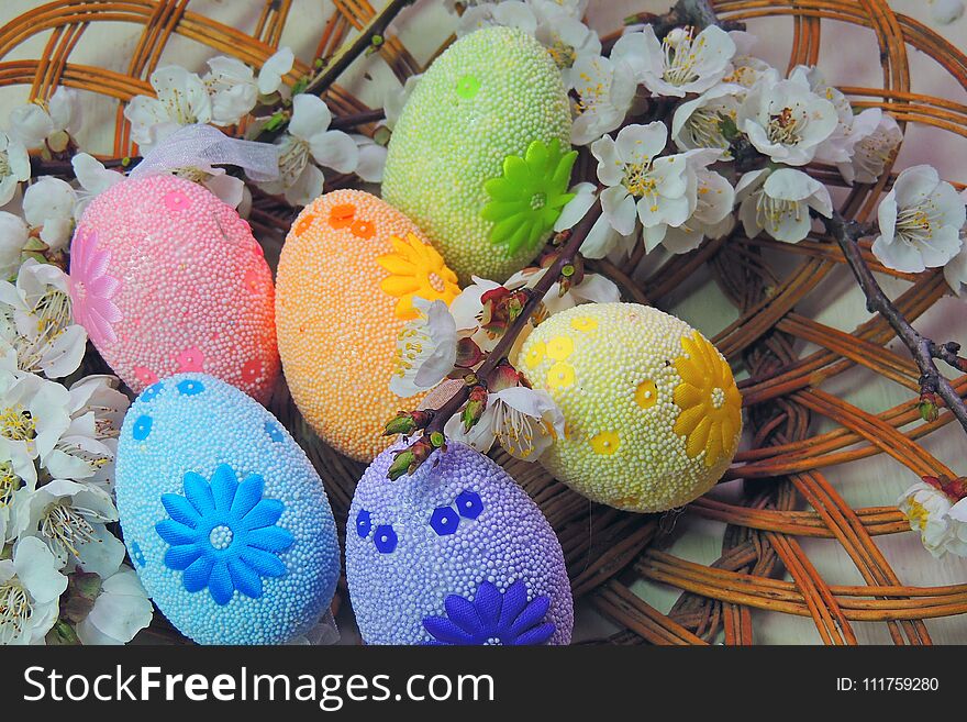 Painted Easter eggs basket and cherry tree blossom. Painted Easter eggs basket and cherry tree blossom