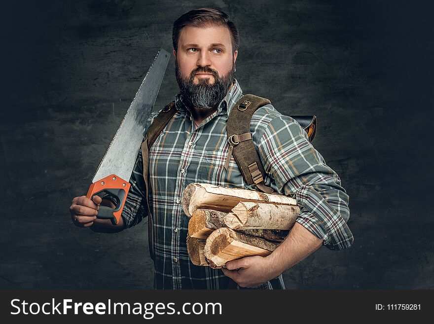 A Man Holds Fire Woods And Hand Saw.