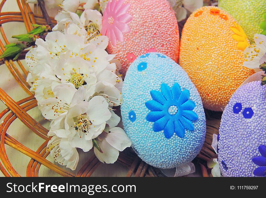 Painted Easter eggs basket and cherry tree blossom. Painted Easter eggs basket and cherry tree blossom