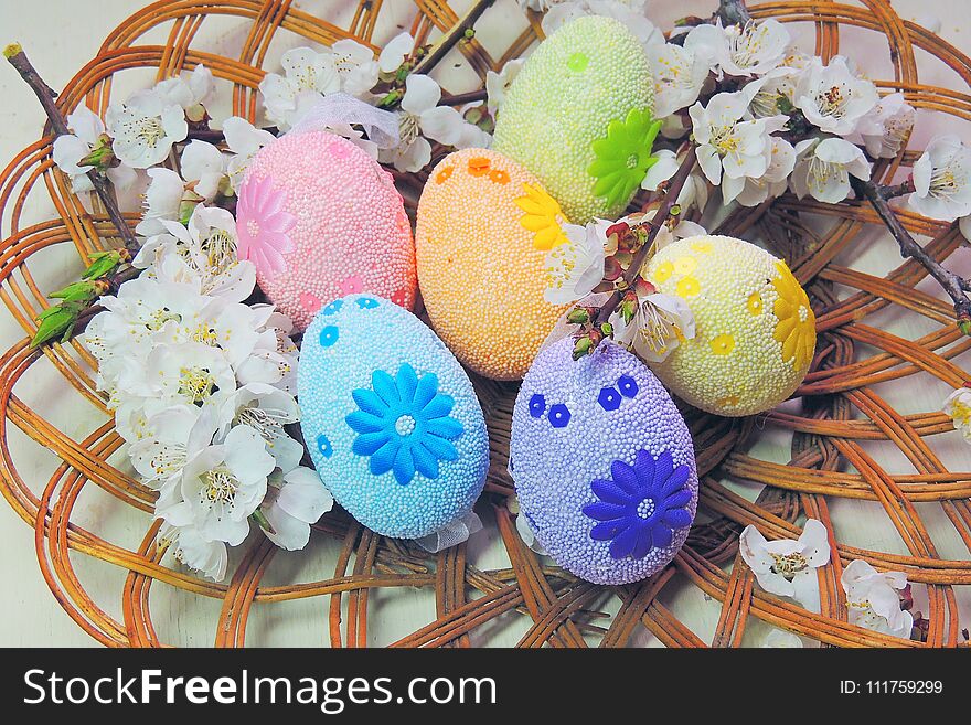 Painted Easter eggs basket and cherry tree blossom. Painted Easter eggs basket and cherry tree blossom