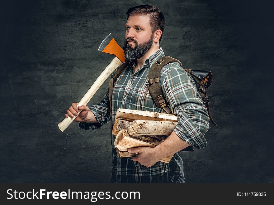Portrait Of Brutal Bearded Hunter Male Holds An Axe On His Shoul