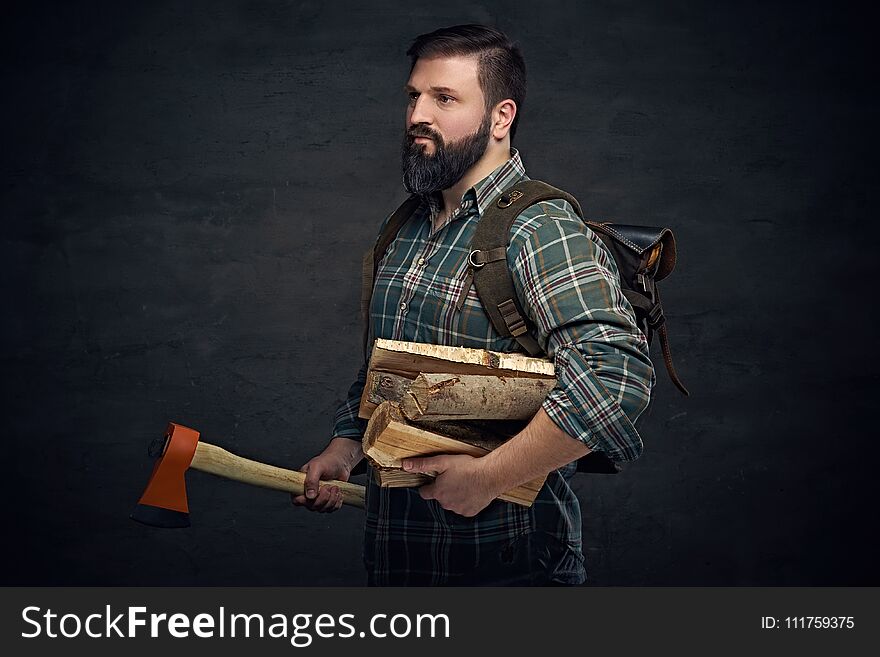 Bearded Middle Age Male Holds An Axe And Firewoods.