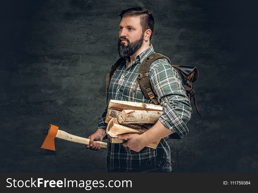 Portrait Of Brutal Bearded Hunter Male Holds An Axe On His Shoul