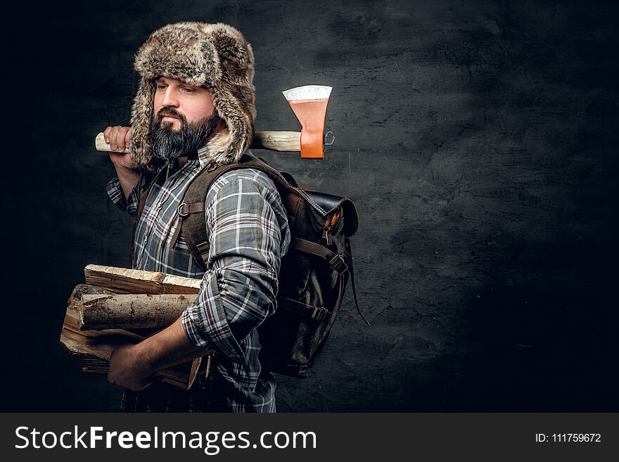 Portrait Of Brutal Bearded Hunter Male Holds An Axe On His Shoul