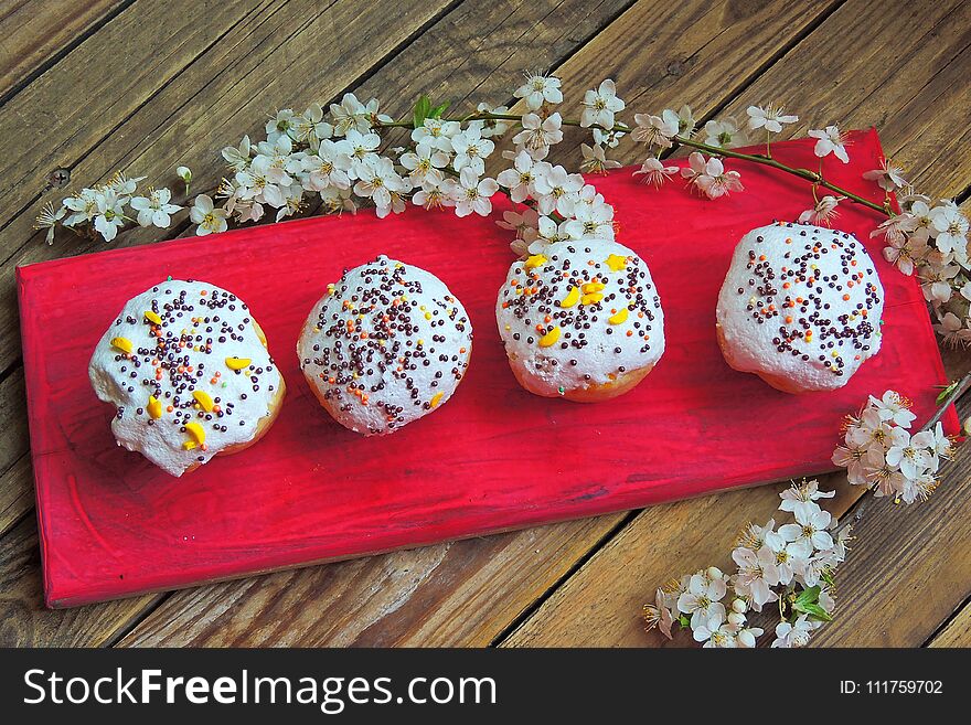 Easter colorful cupcakes on wooden table. Easter cupcakes and a cherry twig