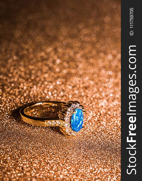 Fashion golden ring decorated with blue fire opal stones. Fashion golden ring decorated with blue fire opal stones.