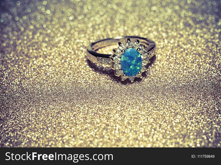 Fashion golden ring decorated with blue fire opal stones. Fashion golden ring decorated with blue fire opal stones.