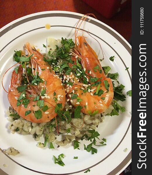 Whole smoked garlic prawns on a bed of wild rice, topped with chopped parsley and sesame seeds. Whole smoked garlic prawns on a bed of wild rice, topped with chopped parsley and sesame seeds.