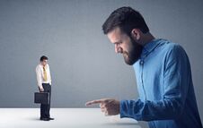 Young Businessman Fighting With Miniature Businessman Stock Images
