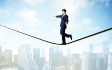 Salesman Walking On Rope Above The City Stock Image