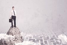 Businessman On Cliff Above Labyrinth Royalty Free Stock Image