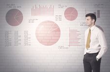 Pie Charts And Numbers On Wall With Salesman Stock Photos
