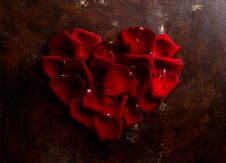Top View Flat Lay Red Rose Petals In Heart Shape On Dark Background. Romance, Passion Concept. Valentines Day Royalty Free Stock Images