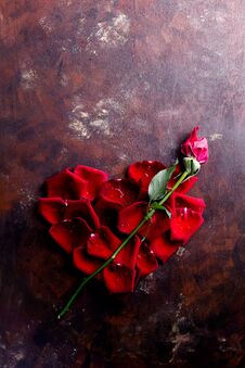 Top View Flat Lay Red Rose Petals In Heart Shape On Dark Background. Romance, Passion Concept. Valentines Day Royalty Free Stock Images