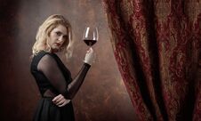 Portrait Of Beautiful Young Woman With Red Wine. Royalty Free Stock Image