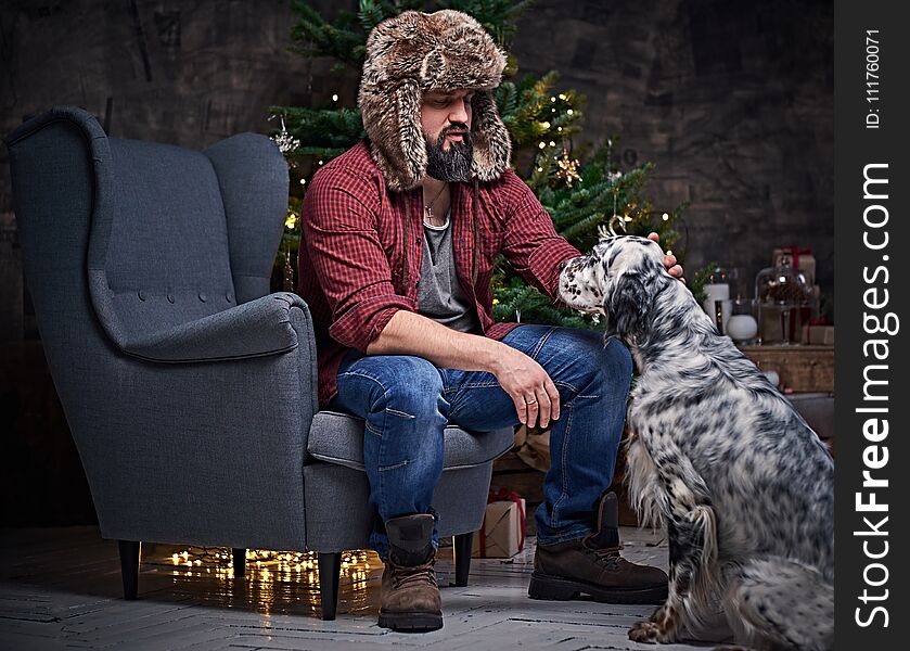 A Man In Fur Hat And Irish Setter Dog.