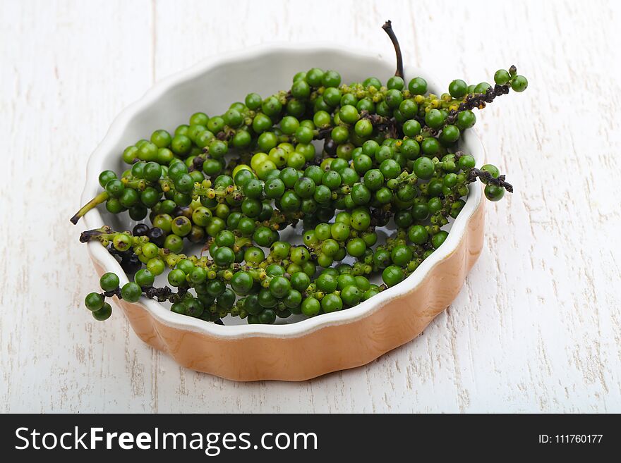 Green pepper corn on the branch in plate