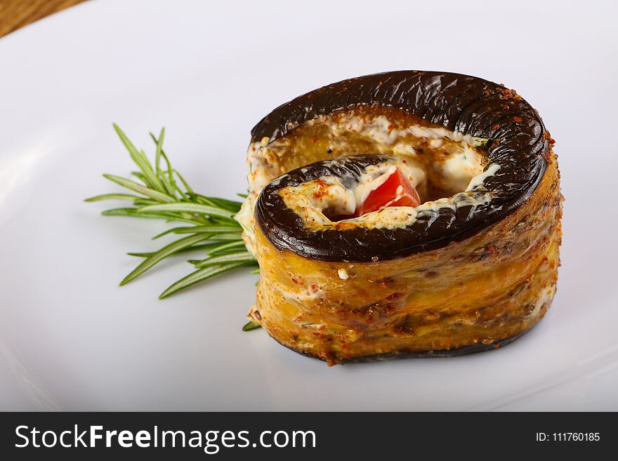 Stuffed eggplant with tomato and rosemary branch