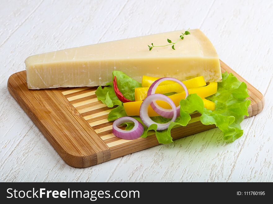 Parmesan cheese triangle on the wood background