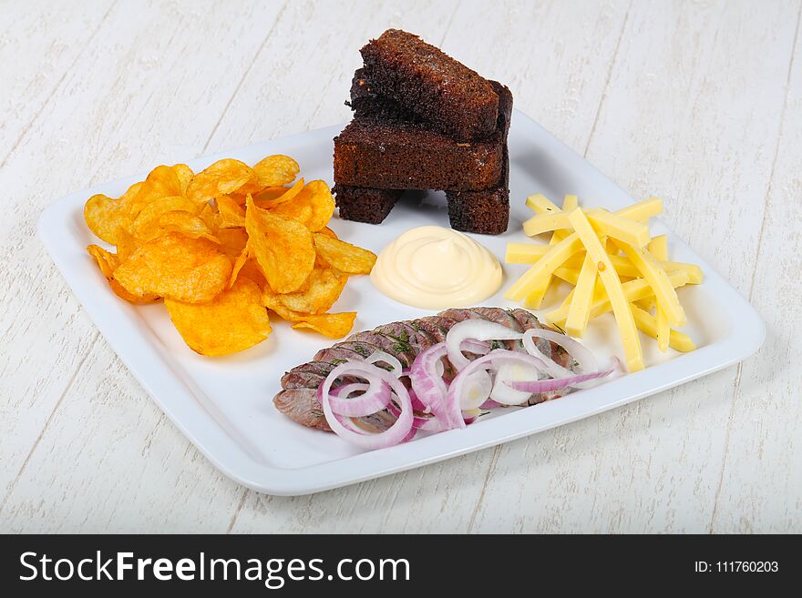 Snack mix - bread, chips and harring with sauce