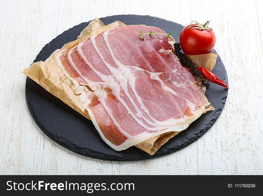 Jamon serrano with pepper and thyme leaves