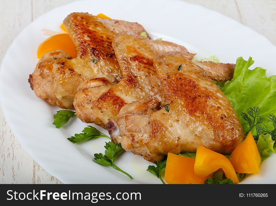 Roasted Chicken wings served salad leaves and parsley