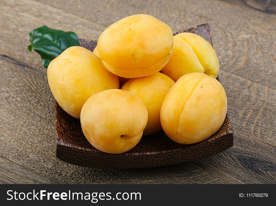 Fresh ripe sweet yellow apricots on the wood background. Fresh ripe sweet yellow apricots on the wood background