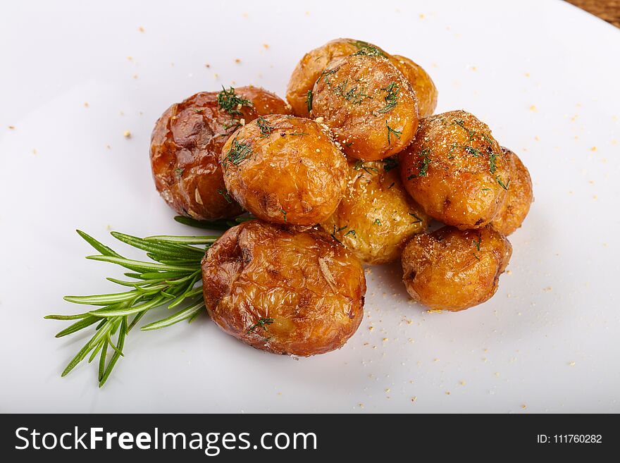 Young baked potato with dill and rosemary