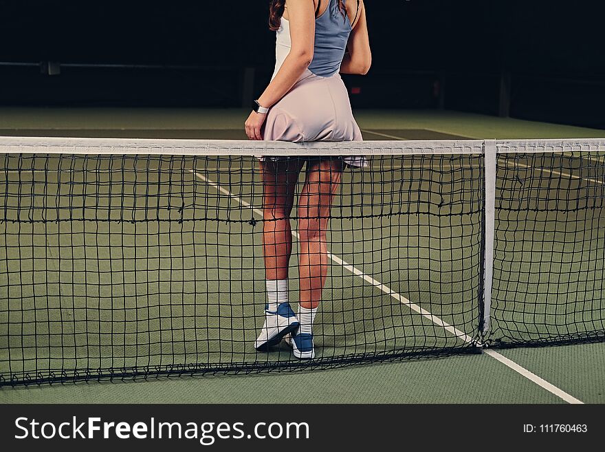 Female Tennis Player Posing On A Tennis Court.