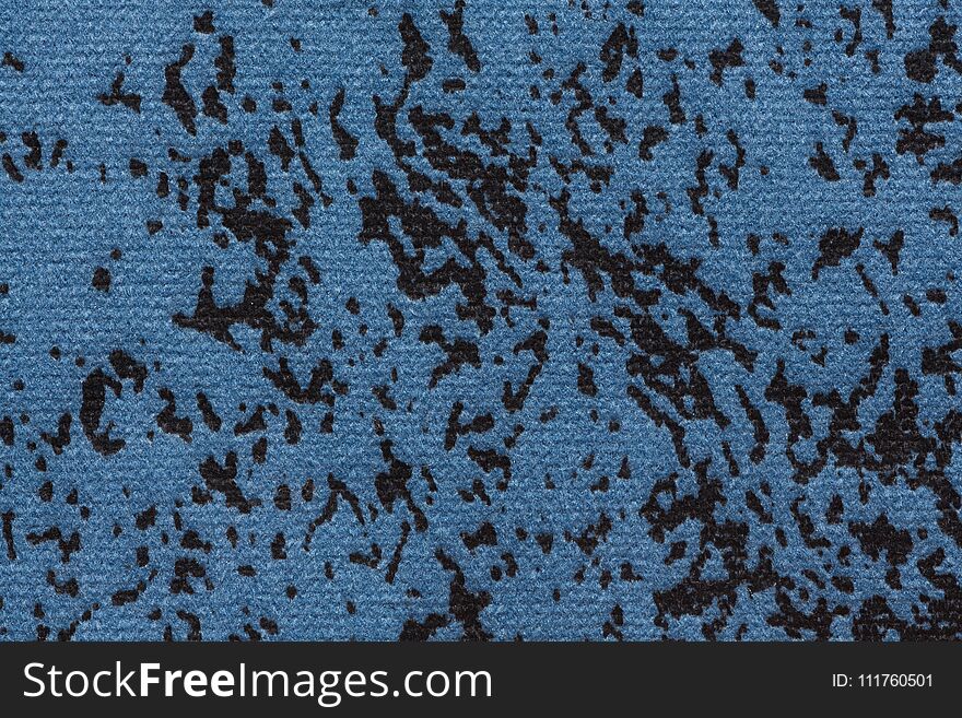 Saturated speckled fabric texture in dark blue tone.