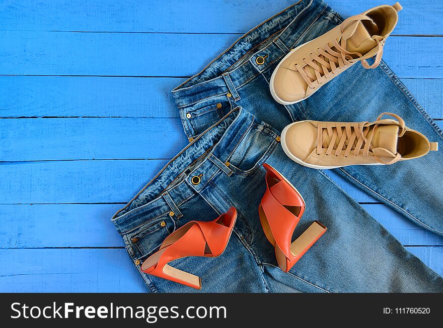 Womens clothing, footwear blue jeans, leather terracotta heel shoes, nude sneakers. Fashion outfit. Shopping concept. Flat lay. Trendy, saturated colors. Spring summer collection