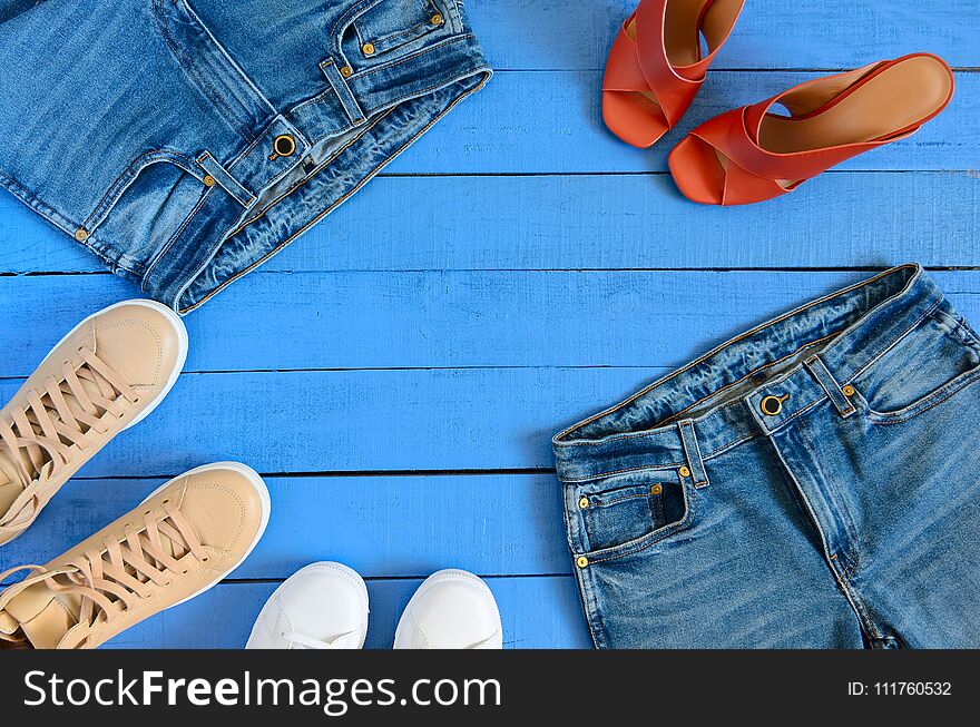 Womens clothing, footwear blue jeans, leather terracotta heel shoes, nude sneakers. Fashion outfit. Shopping concept. Flat lay. Trendy, saturated colors. Spring summer collection