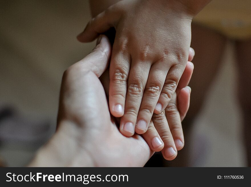 Hands of child in mother`s hand. Mother`s Day concept.