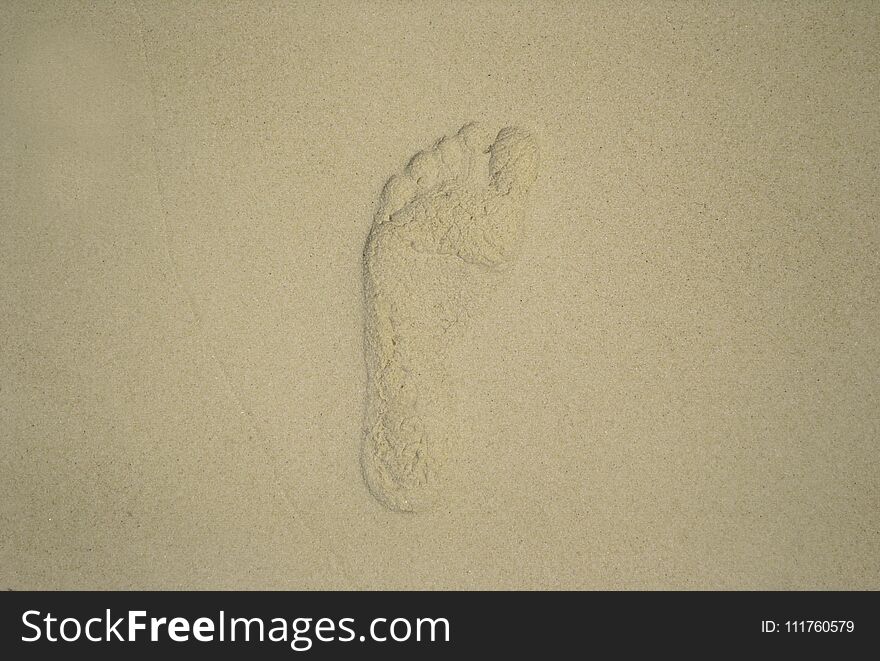 Footprint on the white sand of the Thailand beach. Front view.