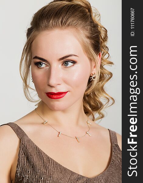 Beautiful curly woman with red lips portrait on a light background.