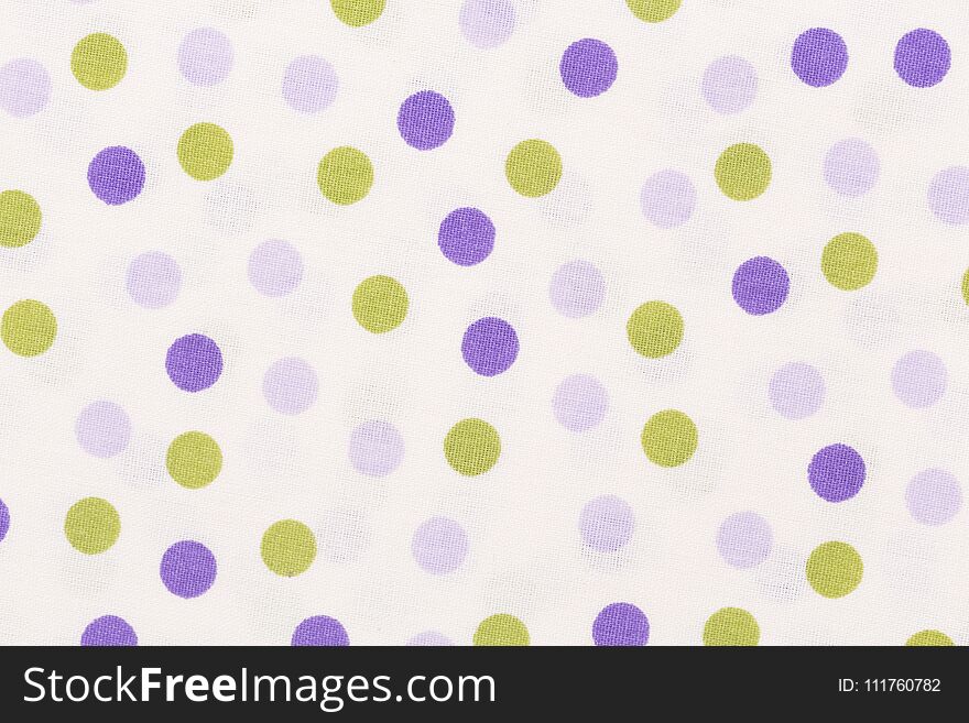 Close up of texture with orange and purple dots on white background.