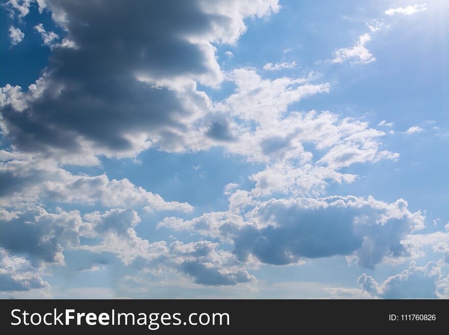 White curly clouds in a blue sky. Sky background.