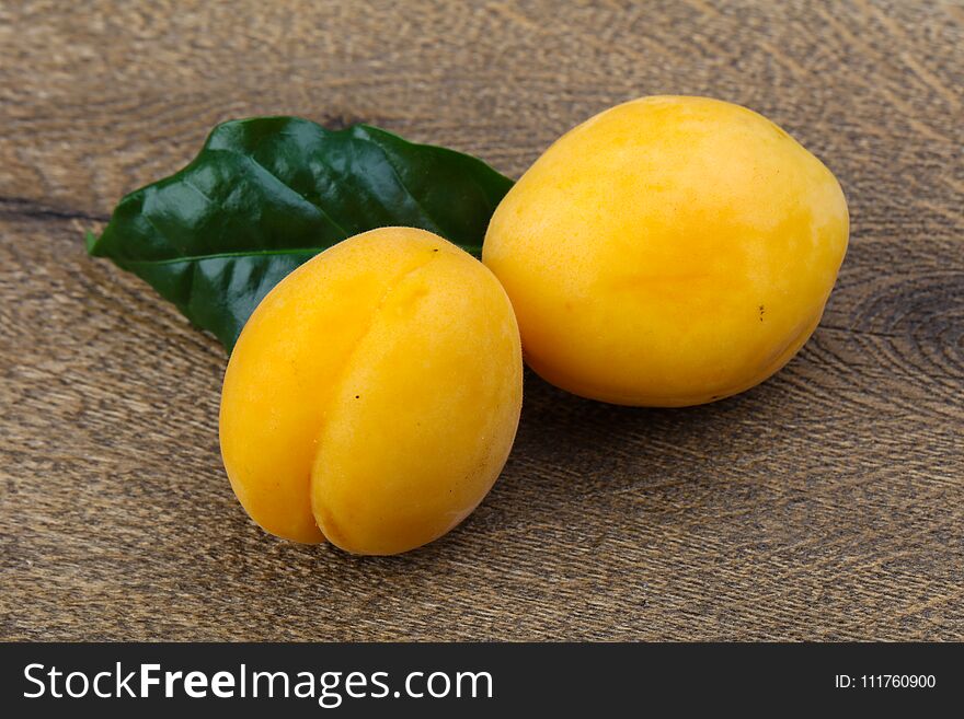 Fresh ripe sweet yellow apricots on the wood background. Fresh ripe sweet yellow apricots on the wood background