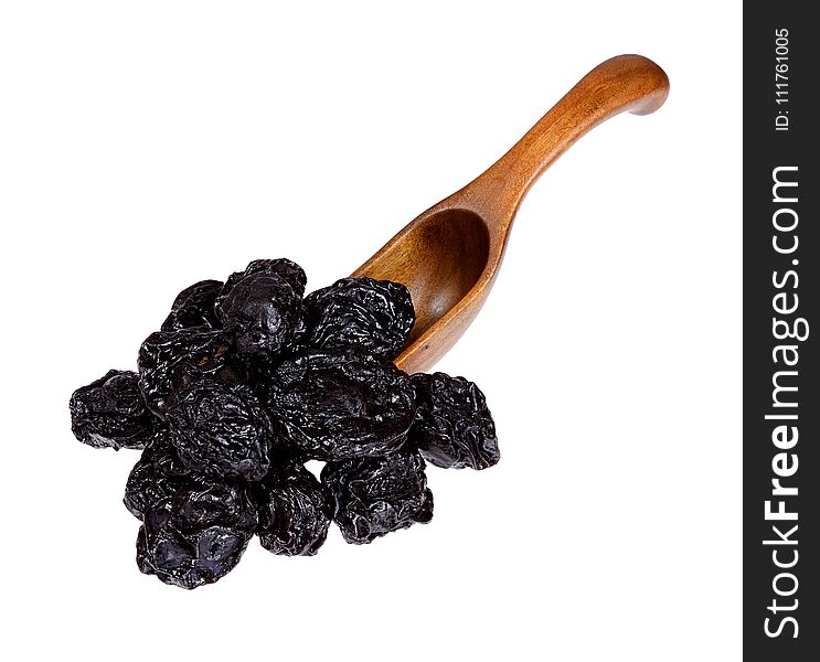 Dried Prunes in the wooden spoon, isolated on white background.