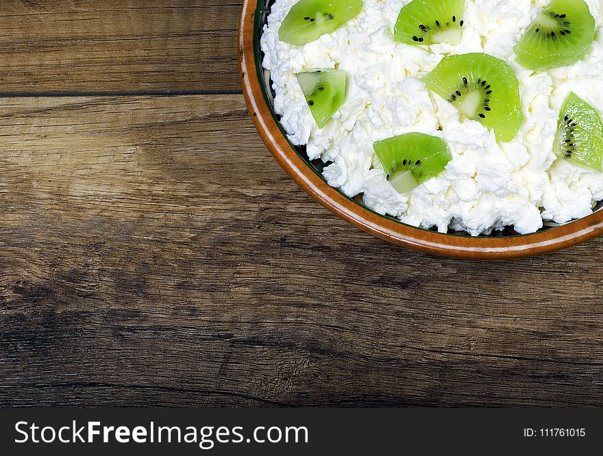 Homemade cottage cheese in a bowl on wooden table .close-up. Homemade cottage cheese in a bowl on wooden table .close-up