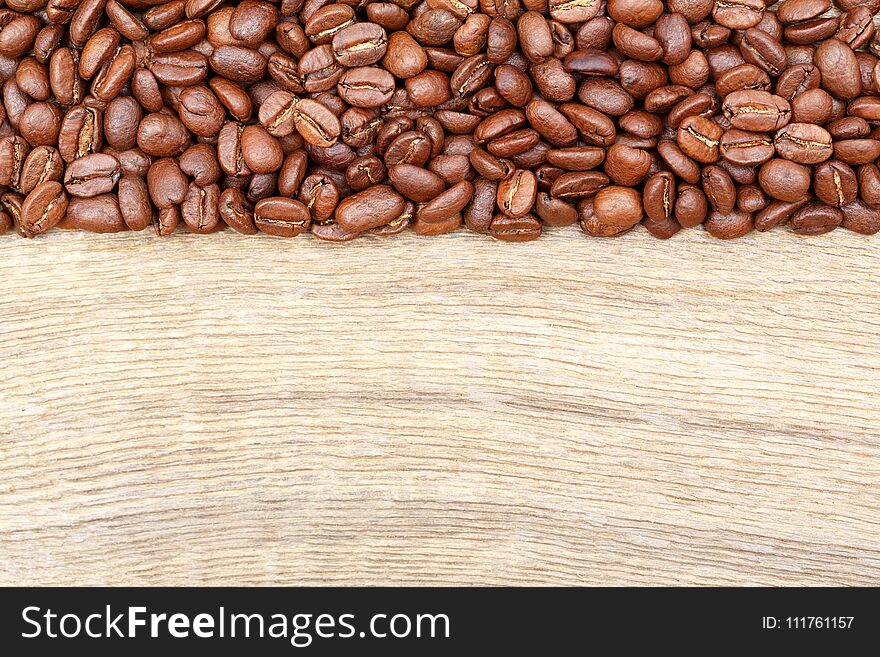 Coffee beans on old wood table. Top view.