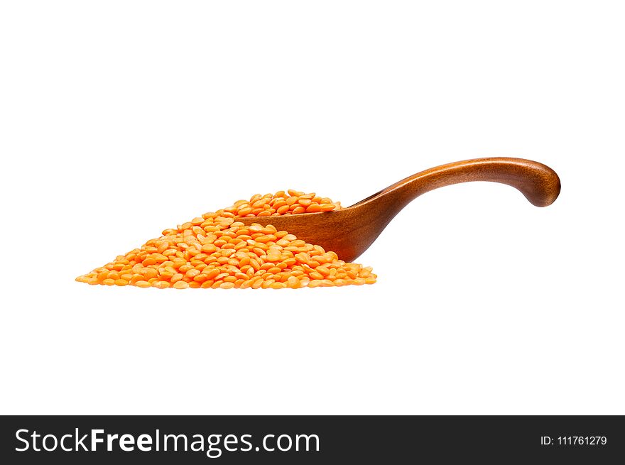 Lentils in the wooden spoon, isolated on white background. High resolution photo.