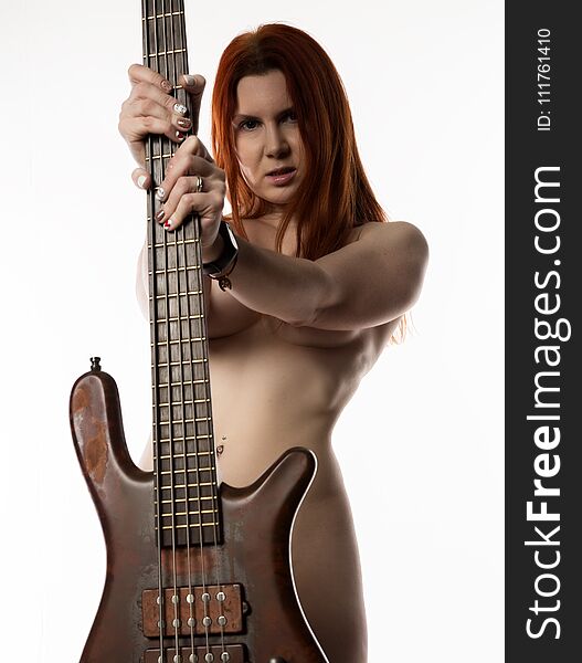 Nude rock woman holding electric guitar on a white background.