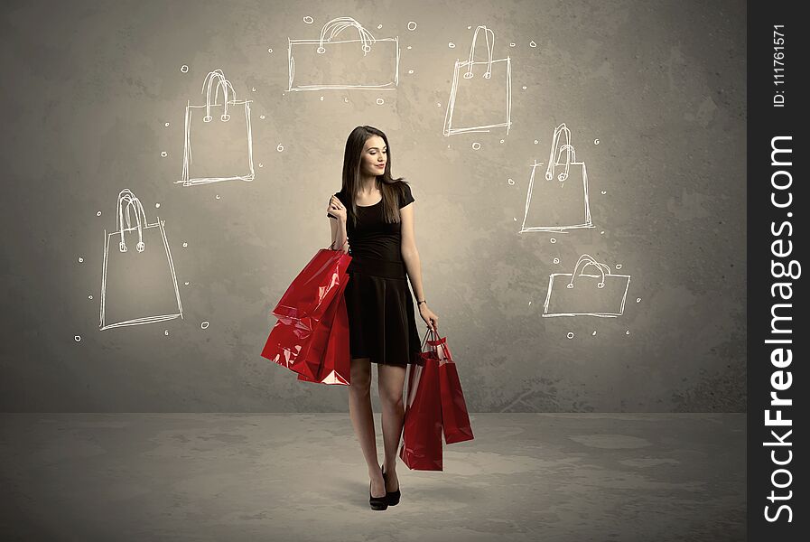 A beautiful young girl in black standing with red shopping bags in front of brown background wall and drawing illustration concept. A beautiful young girl in black standing with red shopping bags in front of brown background wall and drawing illustration concept